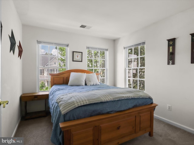 bedroom featuring visible vents, carpet floors, and baseboards
