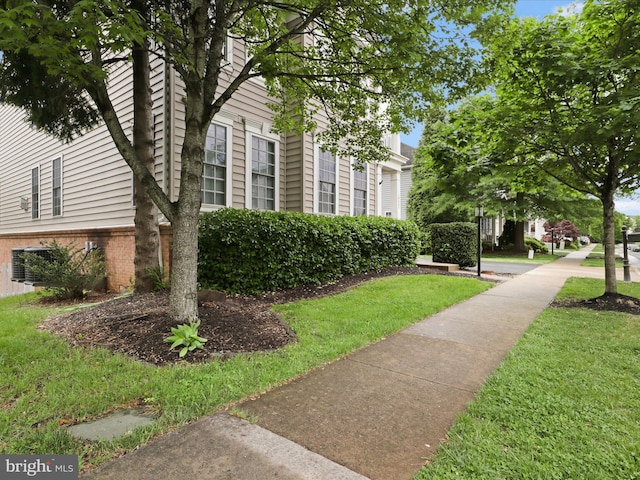 view of home's community featuring a lawn