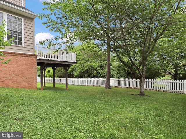 view of yard with a deck and fence