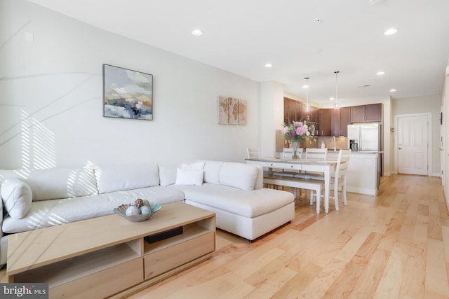 living room with recessed lighting and light wood-type flooring