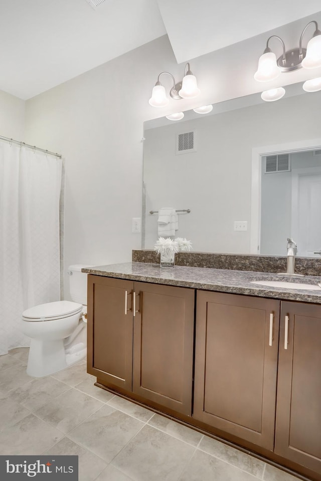 full bath with vanity, tile patterned floors, toilet, and visible vents