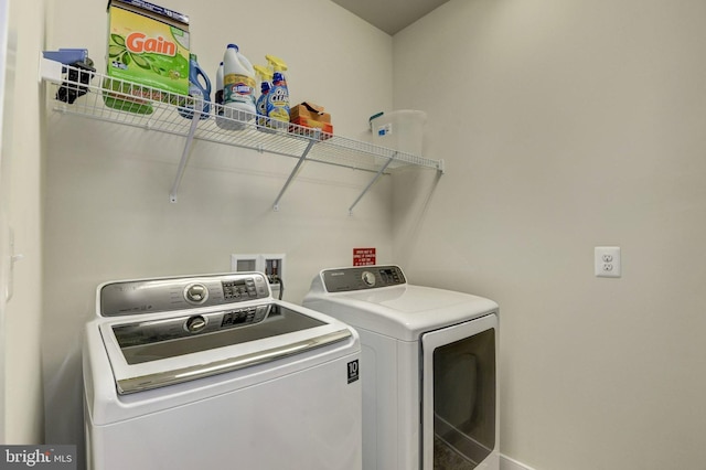 laundry area featuring laundry area, baseboards, and washer and dryer