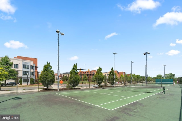 view of sport court featuring fence