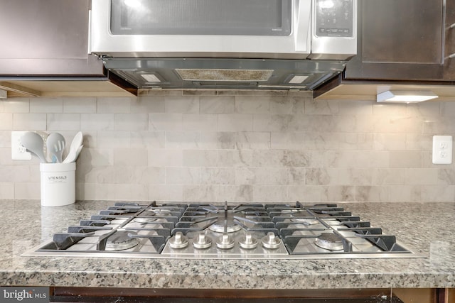 room details with light countertops, appliances with stainless steel finishes, and backsplash