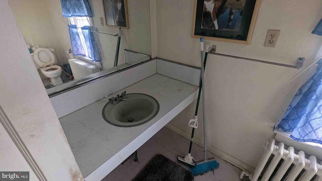bathroom with radiator heating unit and vanity