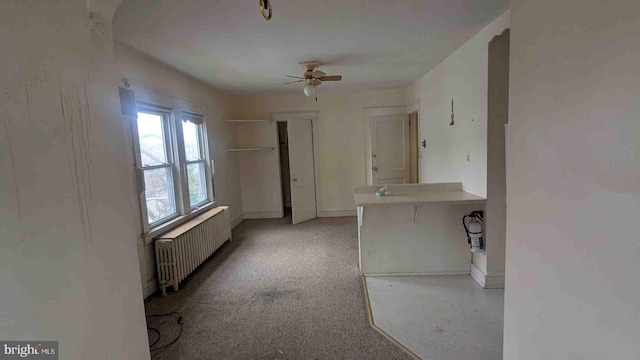 hall with light carpet and radiator heating unit
