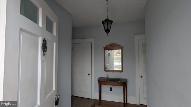 interior space featuring baseboards and wood finished floors