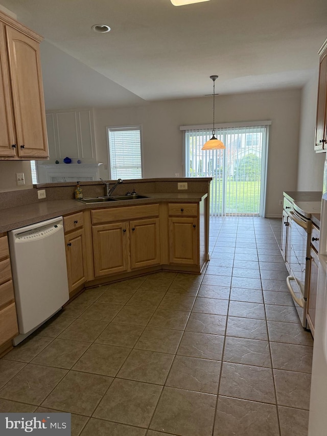 kitchen featuring white dishwasher, range with electric cooktop, a sink, and light brown cabinets