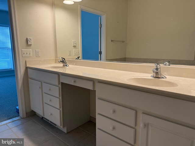 full bathroom with double vanity, a sink, and tile patterned flooring