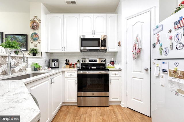 400 Symphony Cir Unit 351, Cockeysville, MD 21030 - kitchen with appliances with stainless steel finishes, white cabinetry, and a sink