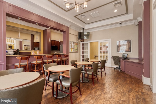 400 Symphony Cir Unit 351, Cockeysville, MD 21030 - dining space with dark wood-style flooring, visible vents, a notable chandelier, crown molding, and a raised ceiling