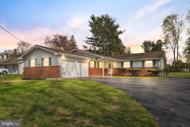 116 Winding Ln, Cinnaminson, NJ 08077 - ranch-style home featuring aphalt driveway, a garage, brick siding, and a lawn