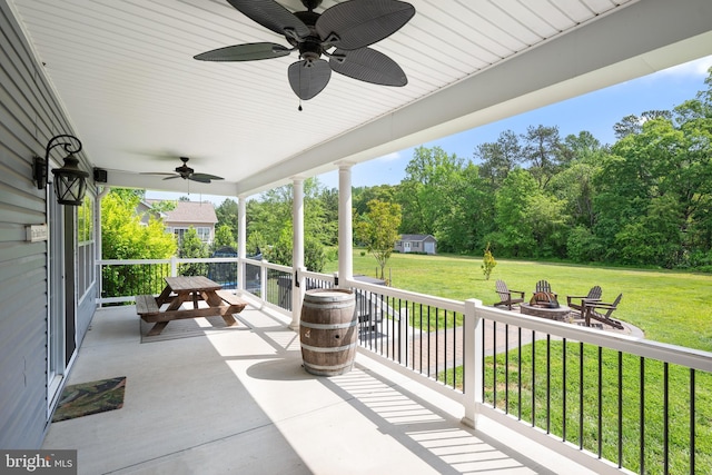 16260 Edgewater Dr, Milton, DE 19968 - view of patio / terrace featuring a ceiling fan, a fire pit, and view of scattered trees