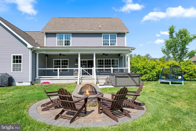 16260 Edgewater Dr, Milton, DE 19968 - back of house featuring a fire pit, a hot tub, ceiling fan, a patio, and a lawn