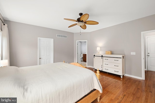 16260 Edgewater Dr, Milton, DE 19968 - bedroom with baseboards, wood finished floors, a ceiling fan, and ensuite bath
