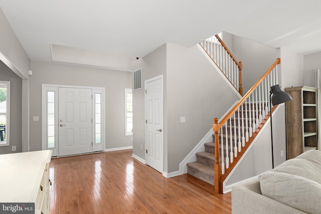 16260 Edgewater Dr, Milton, DE 19968 - foyer featuring light wood-type flooring, stairway, and baseboards