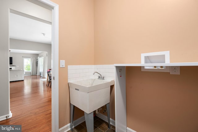 16260 Edgewater Dr, Milton, DE 19968 - laundry room featuring wood finished floors and baseboards