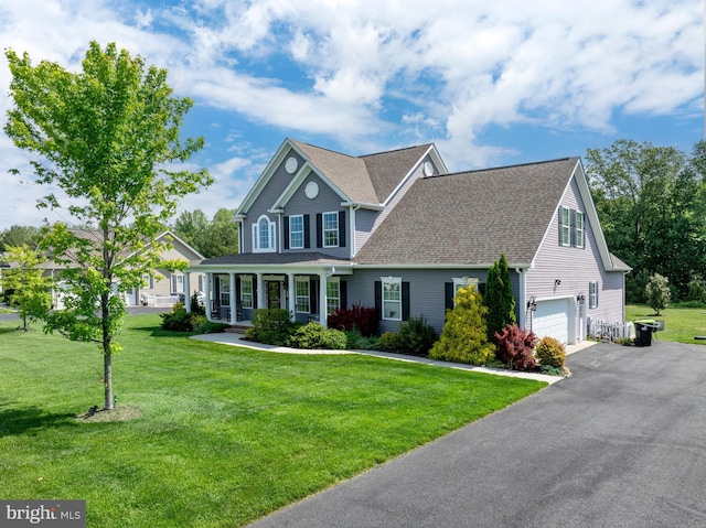 16260 Edgewater Dr, Milton, DE 19968 - traditional-style home featuring a garage, driveway, a front yard, roof with shingles, and covered porch