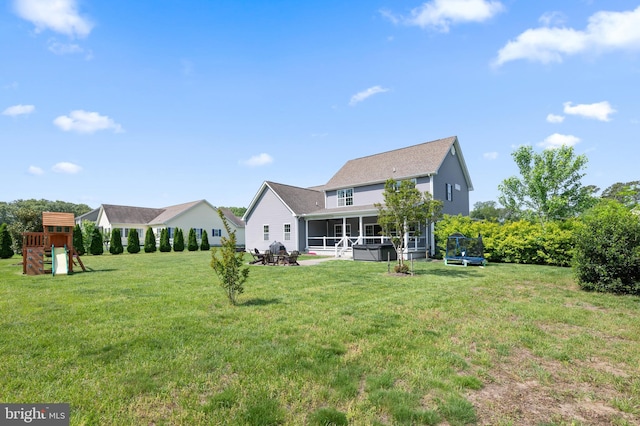 16260 Edgewater Dr, Milton, DE 19968 - rear view of house featuring a sunroom, a playground, a yard, and a trampoline