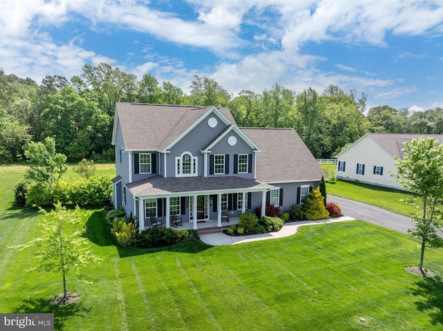 16260 Edgewater Dr, Milton, DE 19968 - view of front of home featuring covered porch, a front yard, a chimney, and a shingled roof