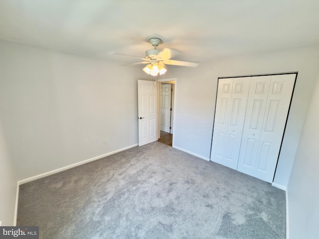unfurnished bedroom with carpet, a closet, a ceiling fan, and baseboards