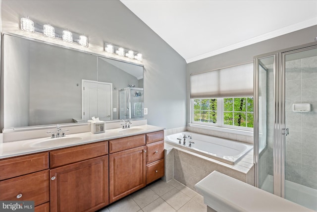 full bathroom with a sink, tile patterned floors, a stall shower, and lofted ceiling