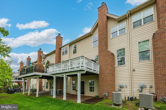 rear view of property featuring central air condition unit, a wooden deck, and a chimney