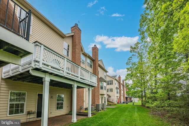 view of property's community with a residential view, a wooden deck, and a yard