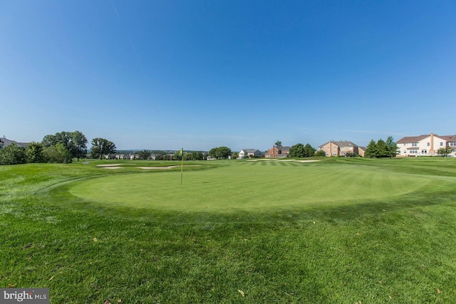 view of property's community with a lawn and golf course view