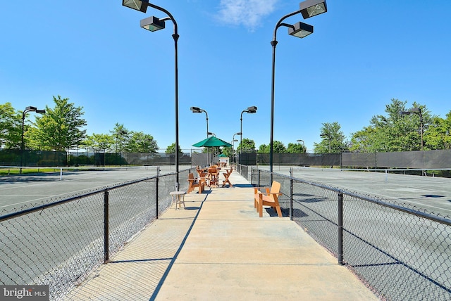 view of tennis court with fence