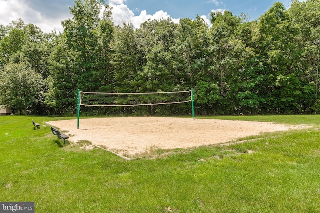 view of property's community featuring volleyball court and a yard