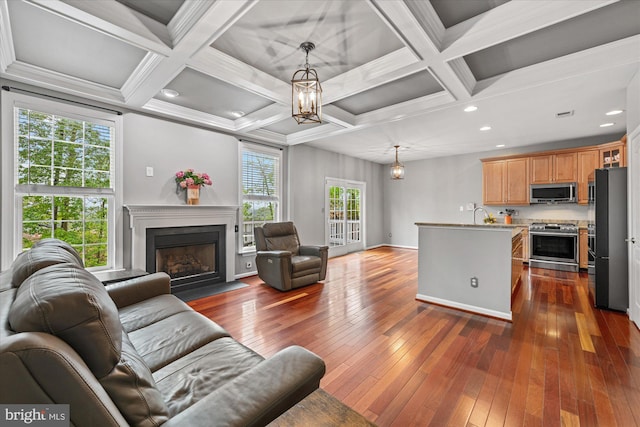 living room featuring a fireplace with flush hearth, coffered ceiling, dark wood-style floors, and beam ceiling