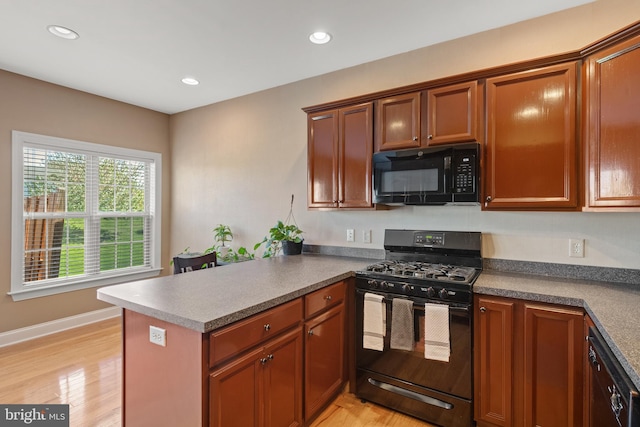 kitchen with recessed lighting, light wood-type flooring, black appliances, and a peninsula