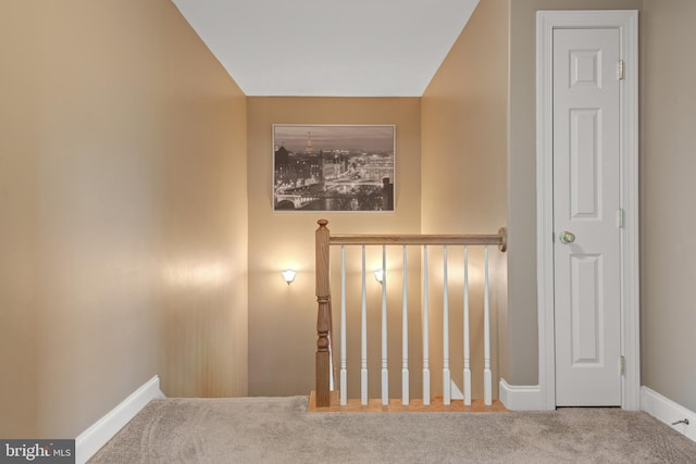 staircase featuring carpet flooring and baseboards