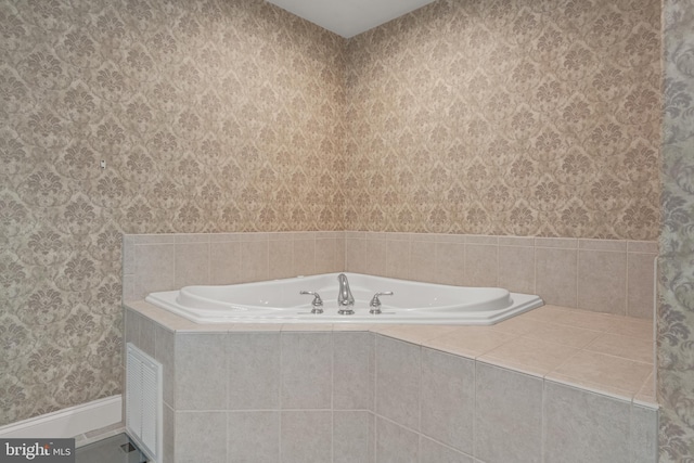 bathroom with a garden tub and wallpapered walls