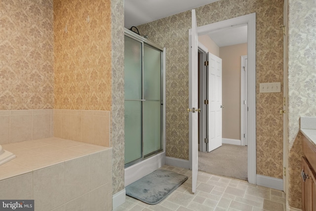 full bathroom featuring wallpapered walls, baseboards, and vanity