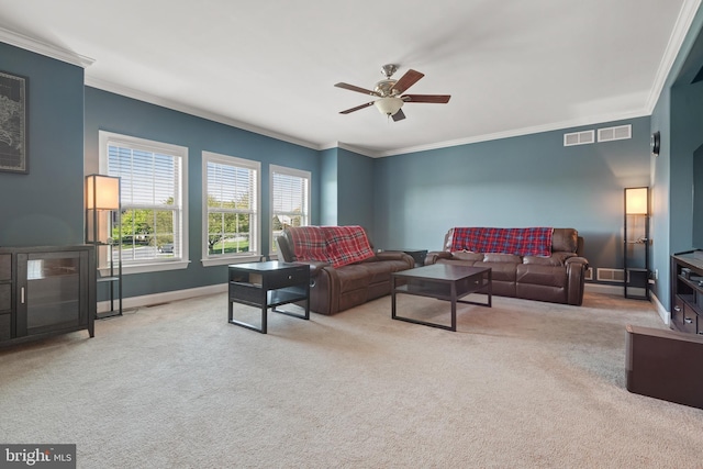 living room featuring crown molding, a ceiling fan, baseboards, and carpet floors