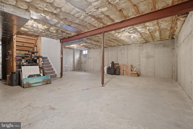 unfinished below grade area featuring stairs