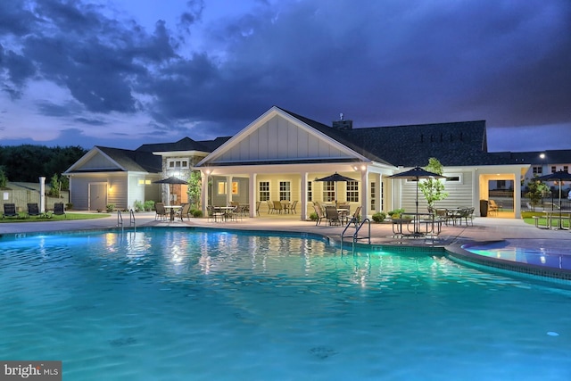 pool with a patio area, a jacuzzi, and outdoor dining space