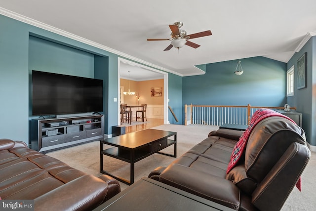 carpeted living room with crown molding and ceiling fan with notable chandelier