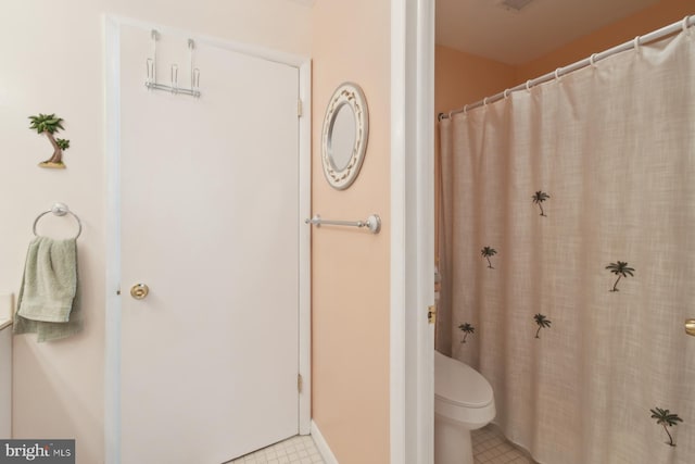 9007 Coastal Hwy, Ocean City, MD 21842 - bathroom with tile patterned flooring, toilet, and curtained shower