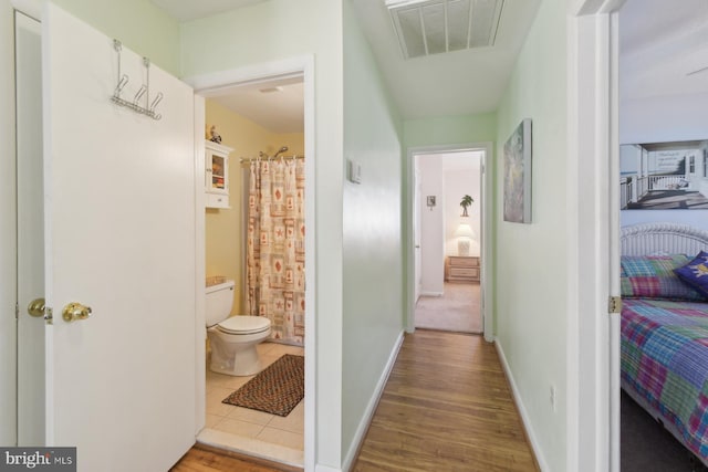 9007 Coastal Hwy, Ocean City, MD 21842 - hall featuring baseboards, wood finished floors, and visible vents