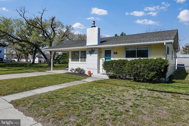 9007 Coastal Hwy, Ocean City, MD 21842 - view of front facade with a chimney, a carport, fence, a front yard, and brick siding