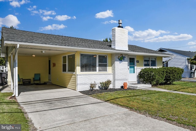 9007 Coastal Hwy, Ocean City, MD 21842 - ranch-style home featuring a carport, a chimney, concrete driveway, a shingled roof, and a front yard