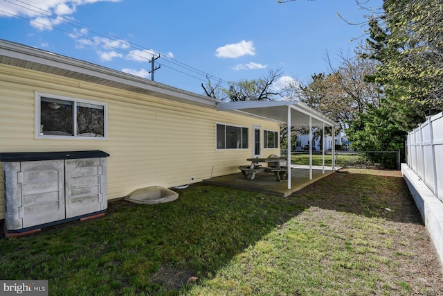 9007 Coastal Hwy, Ocean City, MD 21842 - rear view of house with fence, a yard, and a patio