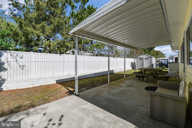 9007 Coastal Hwy, Ocean City, MD 21842 - view of patio / terrace with a storage unit, an outbuilding, and a fenced backyard