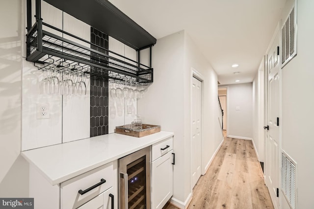 3014 Oakford Ave, Baltimore, MD 21215 - indoor dry bar with beverage cooler, light wood-style floors, baseboards, and recessed lighting