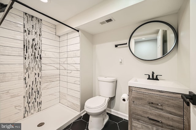 3014 Oakford Ave, Baltimore, MD 21215 - full bathroom featuring toilet, a shower stall, vanity, tile patterned floors, and baseboards
