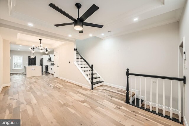 3014 Oakford Ave, Baltimore, MD 21215 - unfurnished living room featuring a raised ceiling, crown molding, recessed lighting, light wood-type flooring, and a chandelier