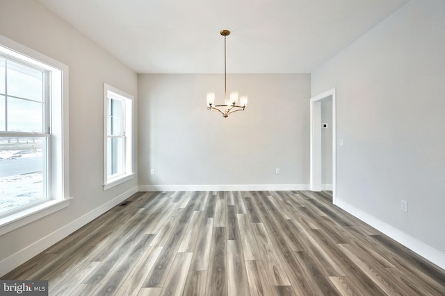 146 Wyndale Dr, Ephrata, PA 17522 - unfurnished dining area featuring a chandelier, wood finished floors, and baseboards